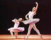 photo of patricia around 11 years old at a ballet recital with her friend